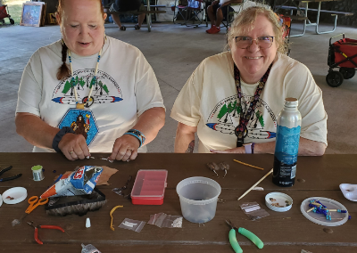 making feather earrings at cultural encampment