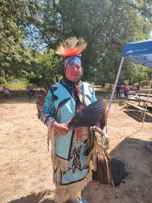 native american man in regalia for dancing