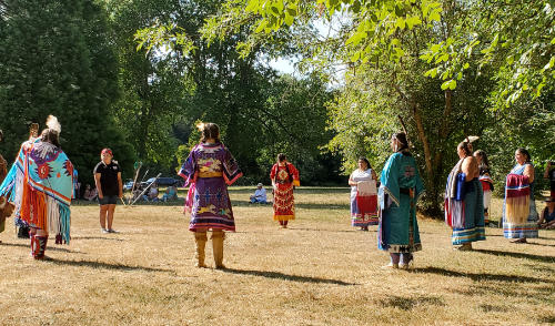 womens fancy powwow dress dancing at park Native